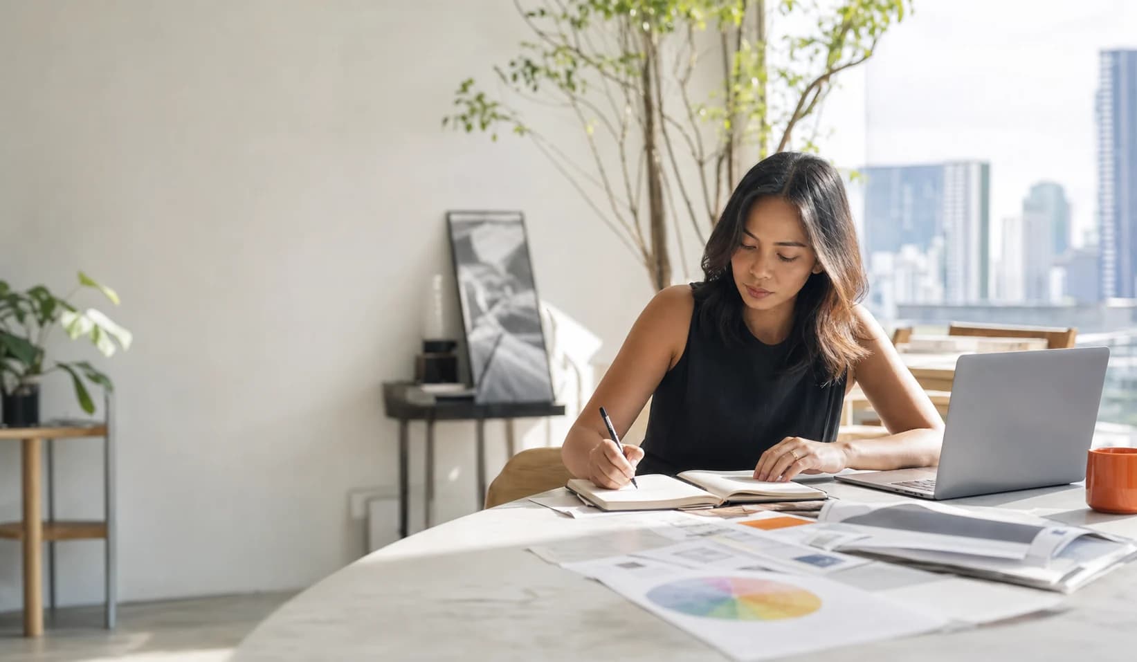 A focused professional planning her day at a bright desk